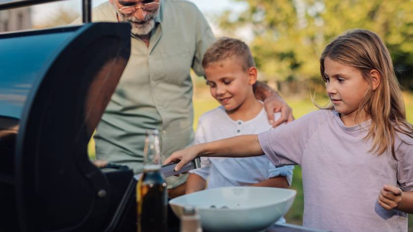 grandfather with grandchildren preparing barbecue 2025 07 20 22 03 53 utc