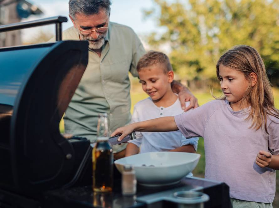 grandfather with grandchildren preparing barbecue 2025 07 20 22 03 53 utc